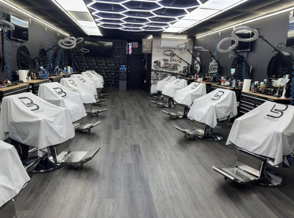The Dream Barbershop interior with modern barber stations and illuminated ceiling